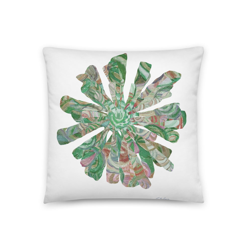 White pillow with green floral collage