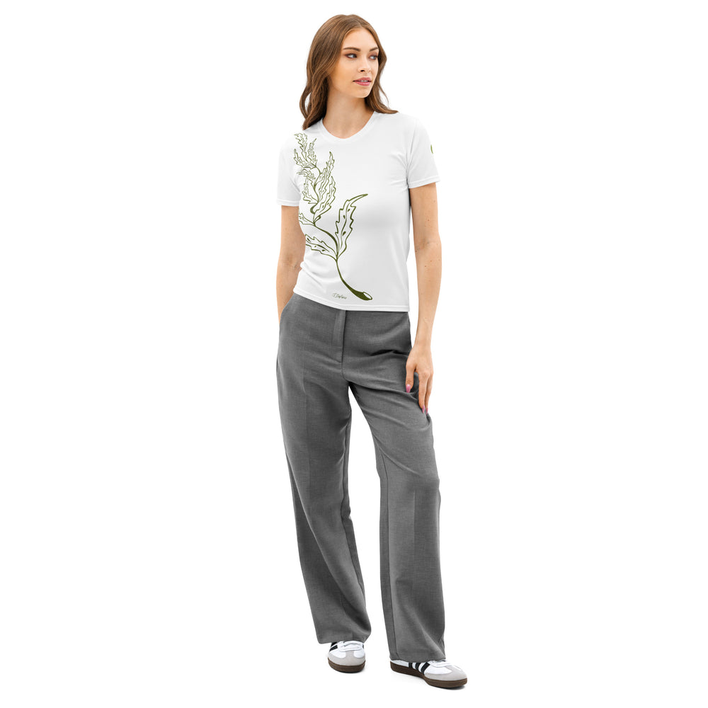 Woman wearing a white t-shirt with a green graphic leaf design and gray pants on a white background