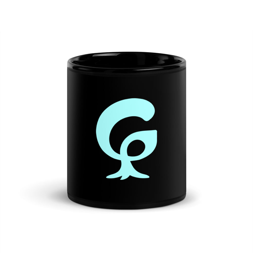 A large graphic letter G printed in bright aqua on a black glossy ceramic mug
