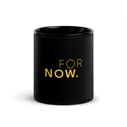 Words FOR NOW printed in yellow on a black glossy ceramic mug