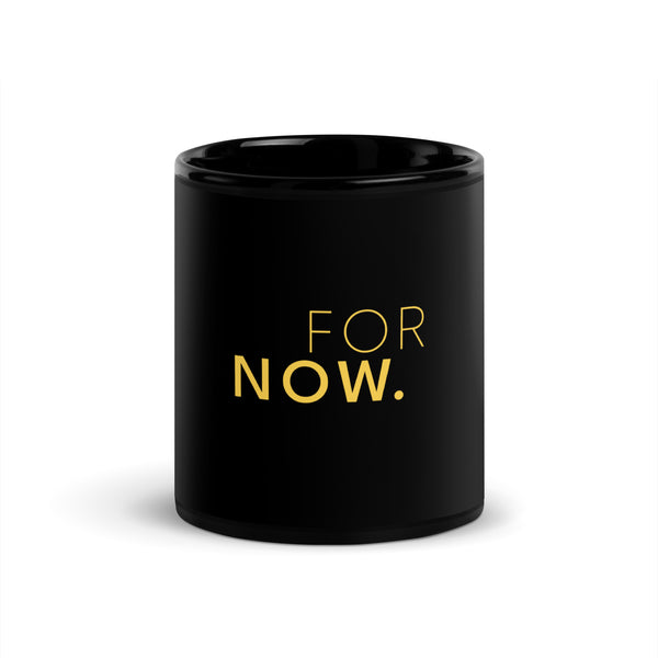 Words FOR NOW printed in yellow on a black glossy ceramic mug