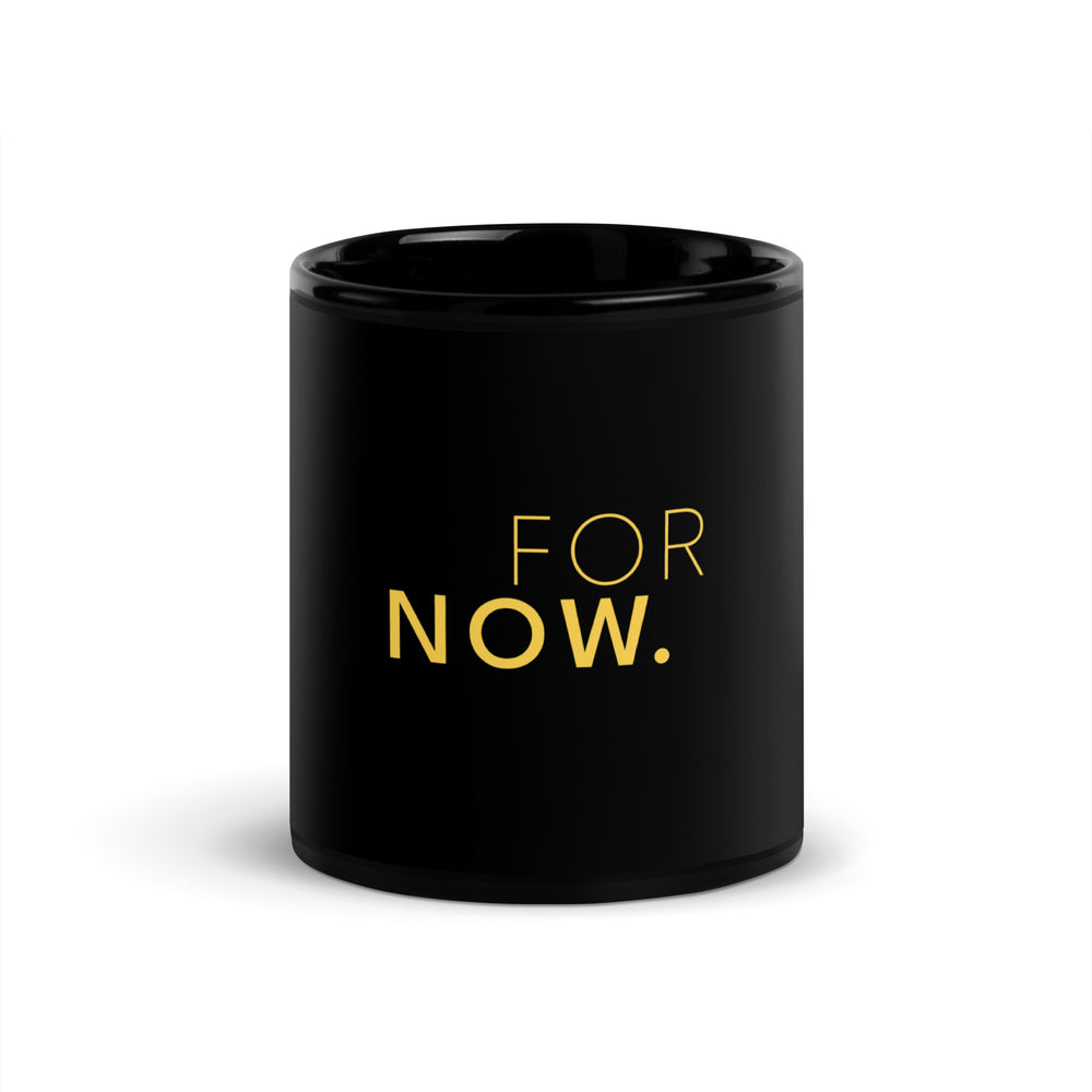 Words FOR NOW printed in yellow on a black glossy ceramic mug