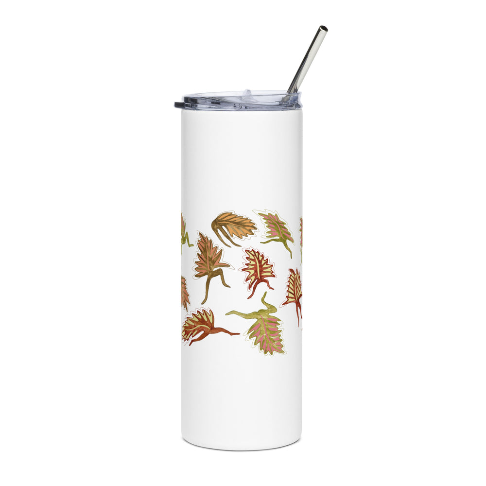 White tumbler with leaf pattern and metal straw on a white background