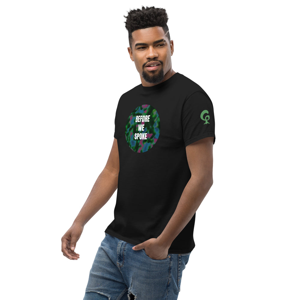 Man wearing a black t-shirt with a graphic design on a black background
