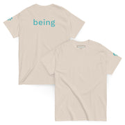 Beige t-shirt with 'being' text on a beige background