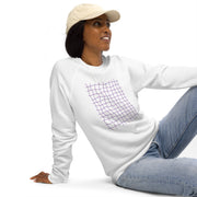 Woman wearing a white hoodie with a graphic design, sitting on a white background