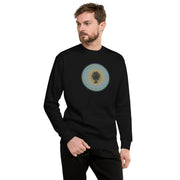 Man wearing a black long-sleeve shirt with a circular design on a black background