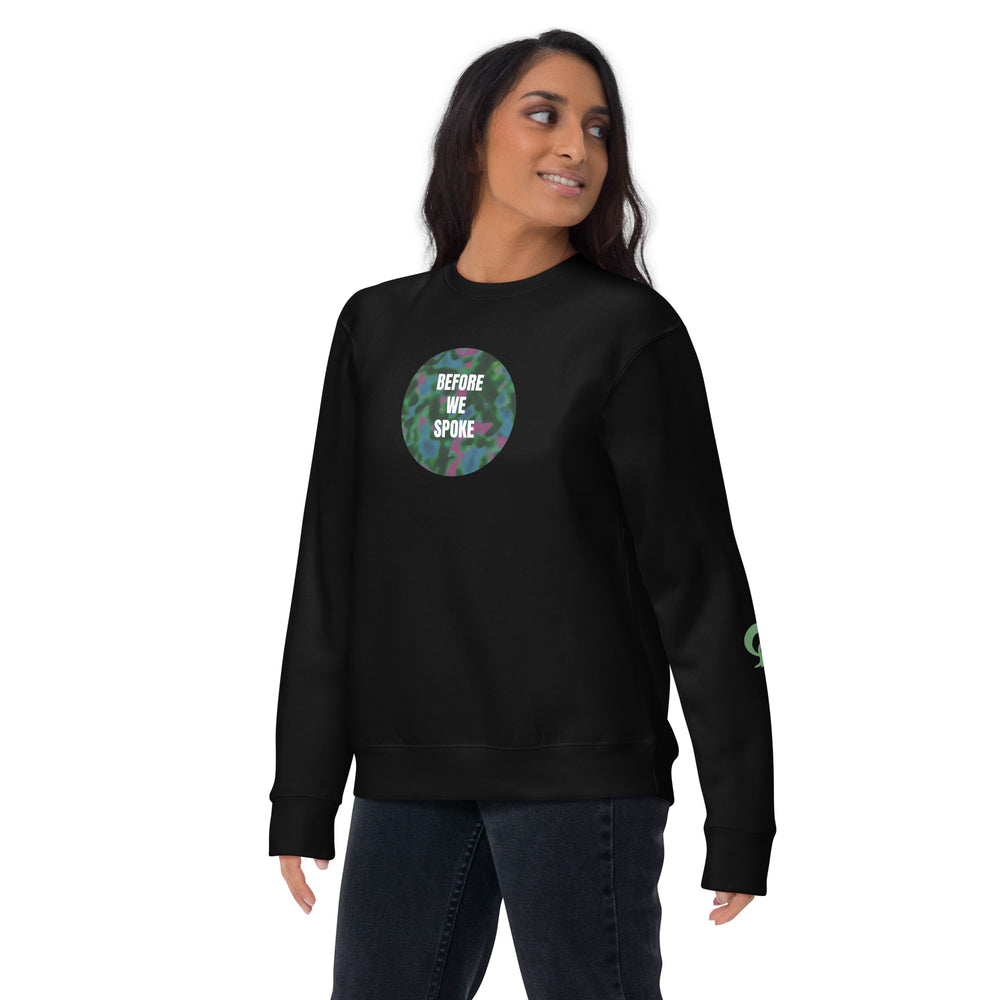 Person wearing a black sweatshirt with a colorful graphic and text on a black background