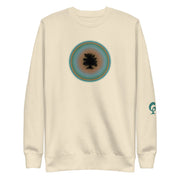 Cream sweatshirt with a circular design on the chest and a logo on the sleeve against a cream background