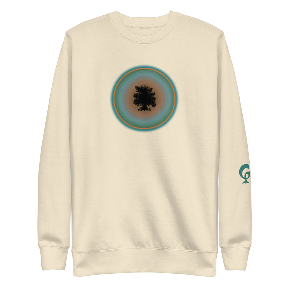 Cream sweatshirt with a circular design on the chest and a logo on the sleeve against a cream background