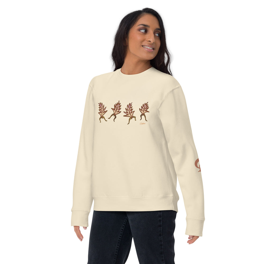 Woman wearing a cream sweatshirt with a design on a cream background