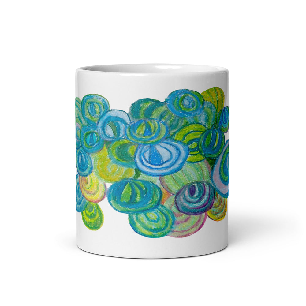 White glossy mug with colorful abstract leaf design on white background