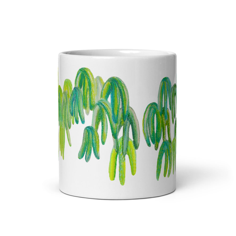 White glossy mug with colorful drooping leaves design on white background 