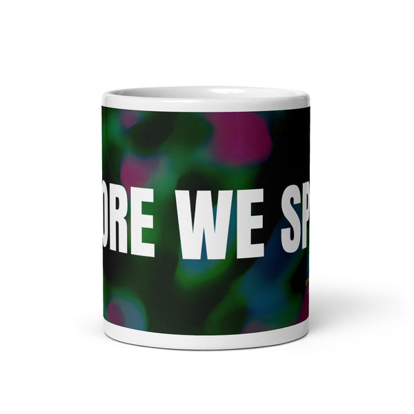 White glossy mug with text BEFORE WE SPOKE on colorful background