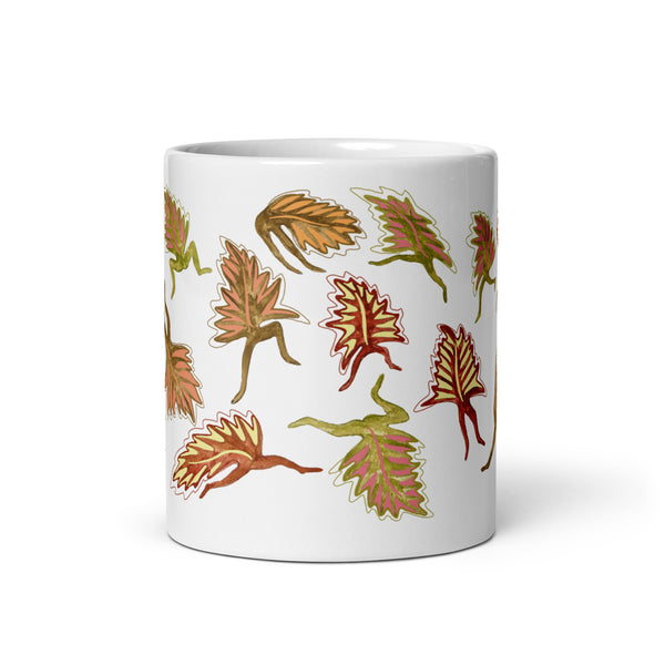 Orange leaves on a white glossy ceramic mug