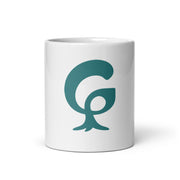 Big organic graphic G printed in teal on a white glossy ceramic mug