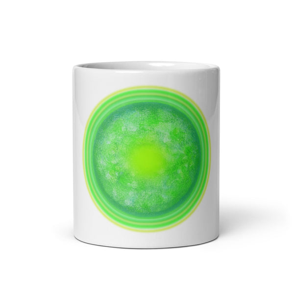 White mug with a green circular design on a white background