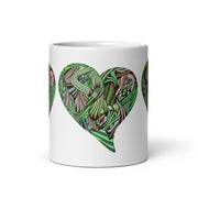 White ceramic mug with graphic hearts in greens on a white background